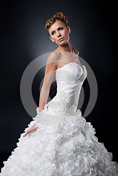 Beautiful young bride in bridal dress posing