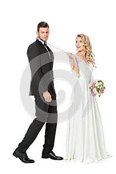 beautiful young bride with chain and leashed unhappy groom