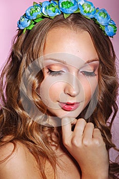 Beautiful young bride with a floral ornament in her hair.Beautiful Woman Touching her Face. Youth and Skin Care Concept