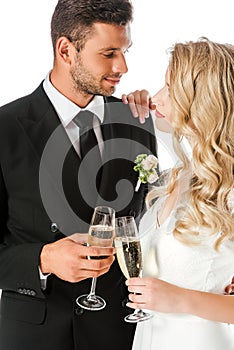 beautiful young bride and groom clinking glasses of champagne