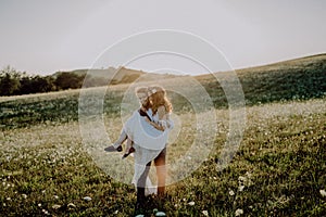 Beautiful bride and groom at sunset in green nature.