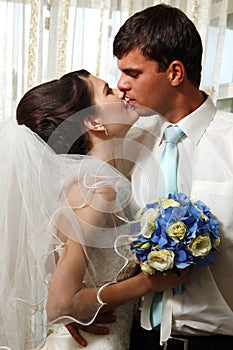 Beautiful young bride kiss groom