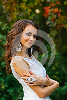 Beautiful young bride with long curly hair