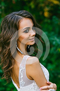 Beautiful young bride with long curly hair