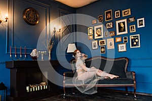 Beautiful young bride in a white lingerie. Last preparations for the wedding. Girl is waiting for the groom