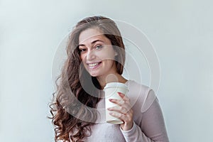 Beautiful young brunete woman with take away paper coffee cup isolated on white background. Happy smiling girl having lunch break