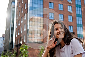 Beautiful young brunette on the background of the city. Happiness expression emotional  lifestyle portrait