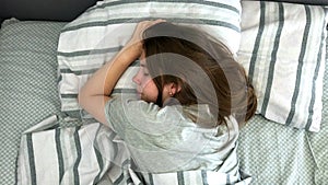 Beautiful Young Brunette Charmingly Sleeps in Her Bed in the Early Hours of the Morning. Sweet and Warm View of Girl