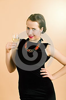 Beautiful young brunette woman holding a glass of white wine