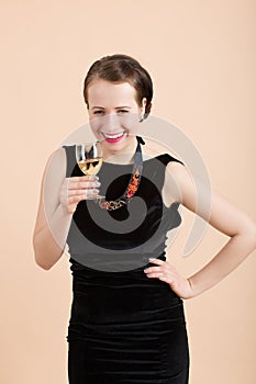 Beautiful young brunette woman holding a glass of white wine