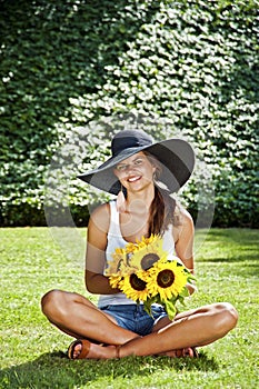 Beautiful young brunette woman on the meadow