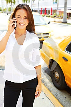 Beautiful young business female talking on cell phone