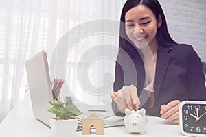 Beautiful young business girl saving money