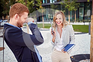 Beautiful young business people laughing in front of a building. colleagues, break, spontaneous