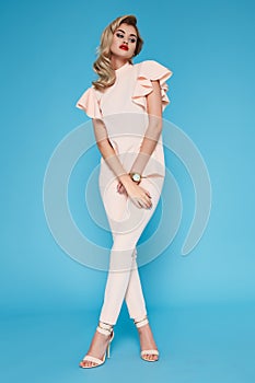 Beautiful young business woman blond hair with evening make-up wearing a dress suit top and high-heeled shoes business cloth