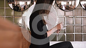 Beautiful young business woman eating a cake with a spoon in a cafe on a bar counter background.