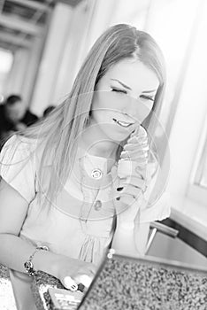 Beautiful young business woman eating ice cream at