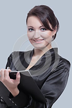 Beautiful young business woman isolated on gray background.