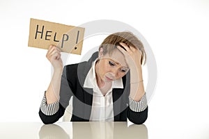 Beautiful young business woman overwhelmed and tired holding a help sign