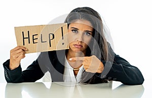 Beautiful young business woman overwhelmed and tired holding a help sign