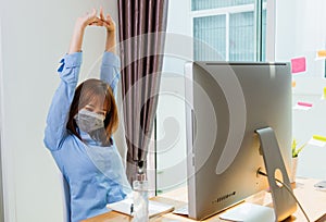 Beautiful young business woman wearing face mask protective quarantines disease coronavirus her stretching her arms