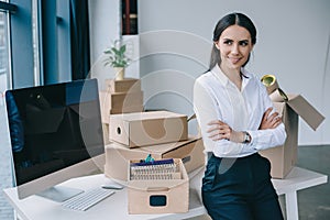 beautiful young businesswoman with crossed arms smiling and looking away