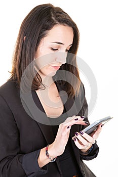 Beautiful young businesswoman dressed in corporate clothing browsing wireless on cell telephone mobile phone while standing under