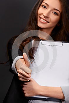 A beautiful young businesswoman giving you the thumbs up