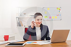 Beautiful young businesswoman making a call by mobile phone