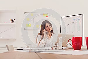 Beautiful young businesswoman making a call by mobile phone