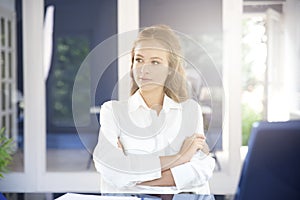 Beautiful young businesswoman portrait while sitting in the office