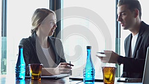 Beautiful young businesswoman professional talking to businessman with partnership together at office
