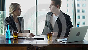 Beautiful young businesswoman professional talking to businessman with partnership together at office