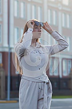 Beautiful young businesswoman standing in the city street