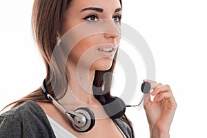 Beautiful young call center office girl with headphones and microphone posing isolated on white background