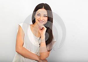 Beautiful young casual cute smiling woman on blue background looking up and thinking. Closeup portrait