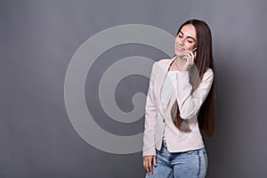 Happy young businesswoman talking on phone