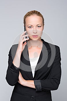 Beautiful young caucasian businesswoman talking on mobile phone.