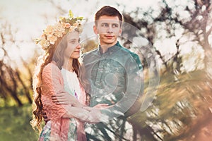 Beautiful young caucasian couple having a romantic date in sunset lights