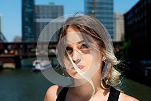 Beautiful Young Caucasian Girl with Barbell septum Nose Ring Horseshoe Nose Ring in Windy City at a sunny day.