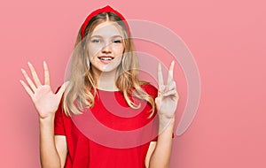 Beautiful young caucasian girl wearing casual red t shirt showing and pointing up with fingers number seven while smiling