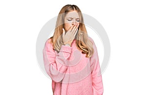 Beautiful young caucasian girl wearing casual winter sweater bored yawning tired covering mouth with hand