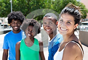 Beautiful young caucasian woman with african american friends in the city