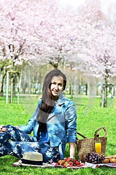 Beautiful Young Caucasian Woman in Blue Leather Jacket Having Picnic in Park