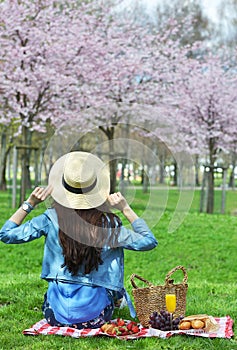 Beautiful Young Caucasian Woman in Blue Leather Jacket Having Picnic with Strawberry Croissant Orange Juice Grape in Japan Cherry