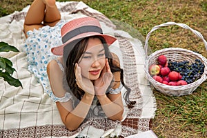 Beautiful young caucasian woman lying in the orchard garden