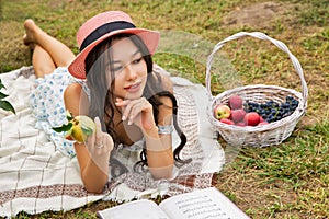 Beautiful young caucasian woman lying in the orchard garden