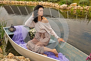 Beautiful young caucasian woman sitting on a boat