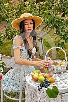 Beautiful young caucasian woman sitting in an orchard