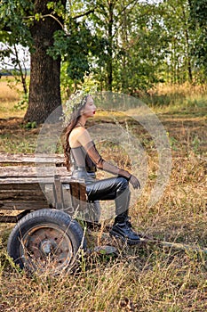 Beautiful young caucasian woman standing the old horse cart